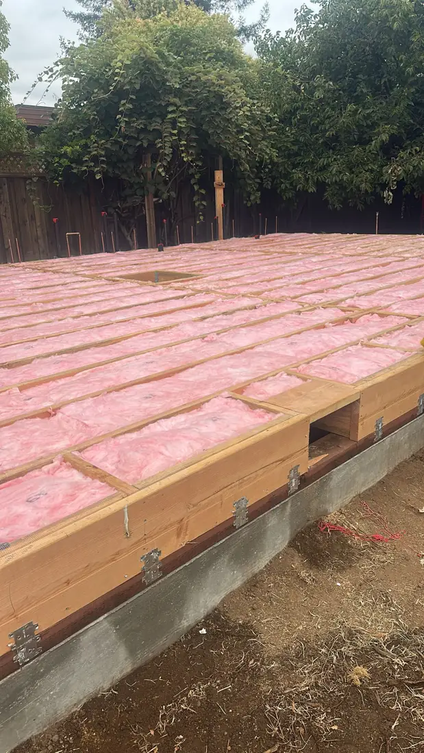 Underfloor batts installed across a new raised foundation before the subfloor