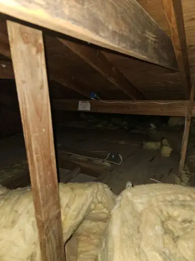 Compressed, dirty attic batts ready to come out