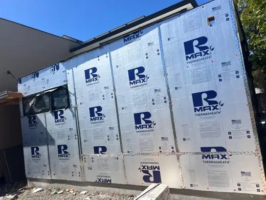 Rmax rigid foam board installed across an exterior wall