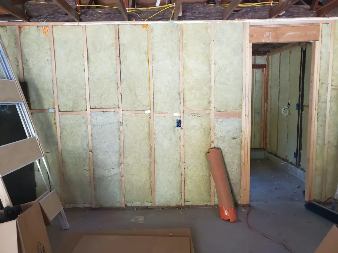 Wall cavities filled with insulation in a remodel